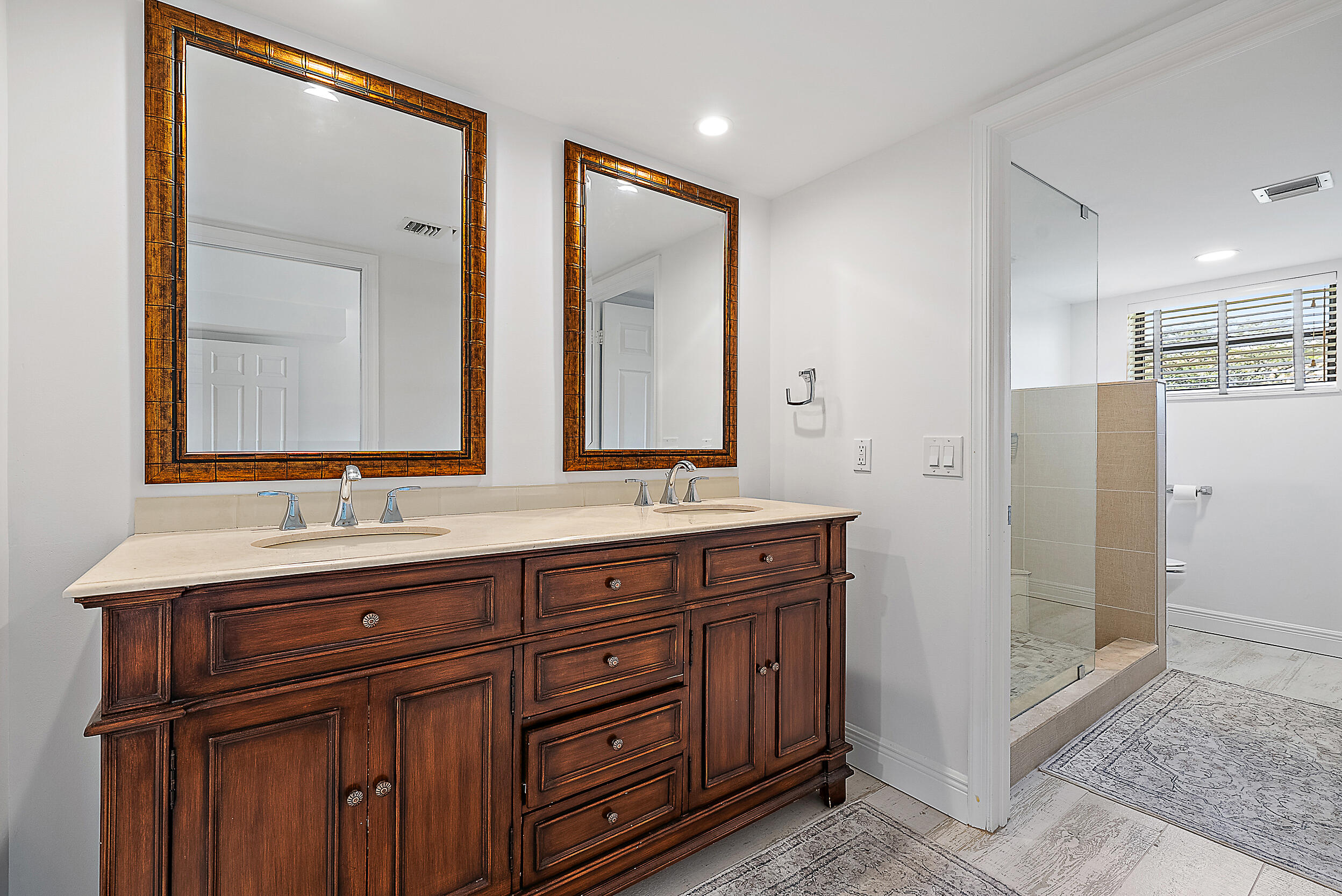 16647 Traders Crossing North, Unit 126 Jupiter, FL 33477 - Photo 21 of 45 a bathroom with double sink and a mirror