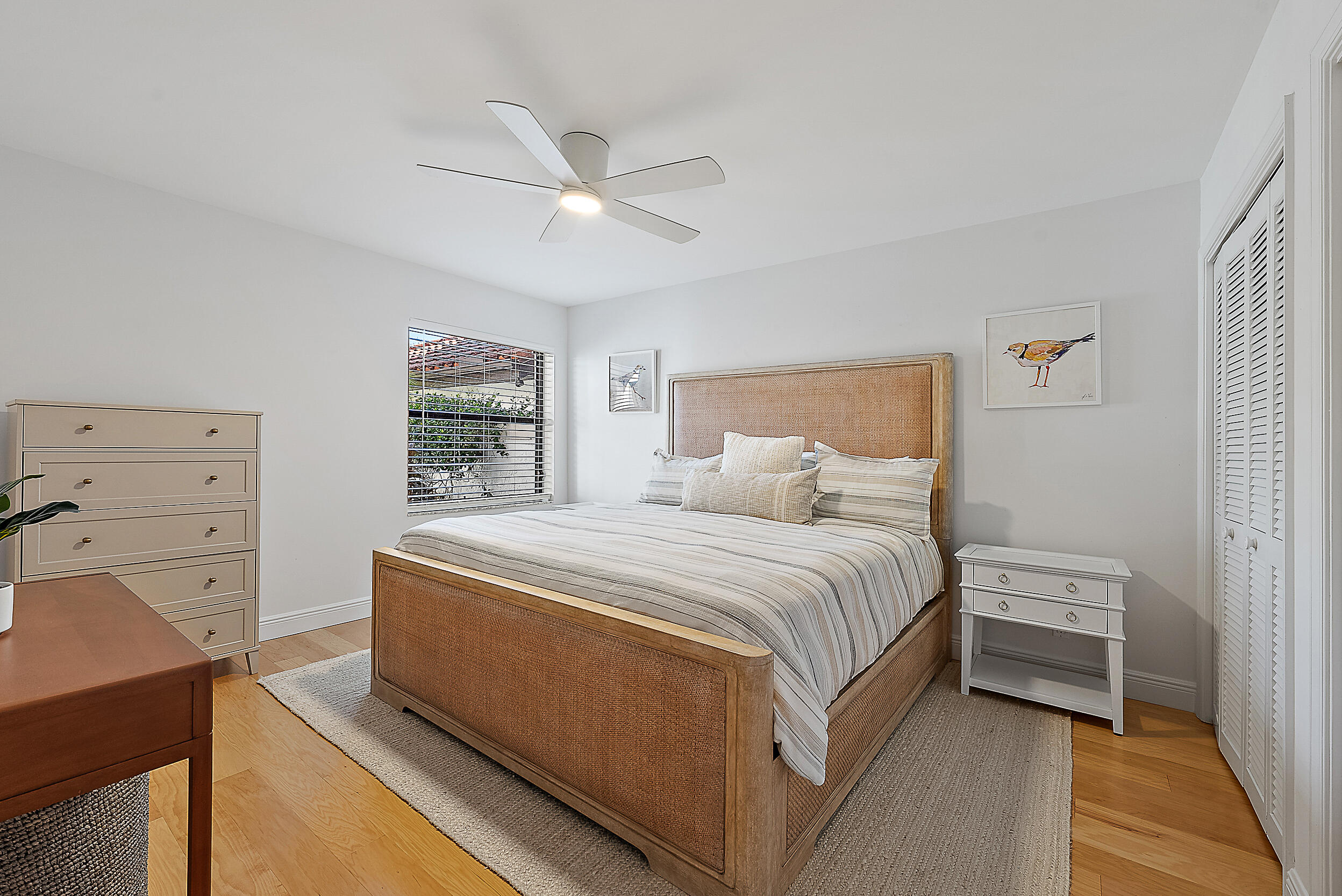 16647 Traders Crossing North, Unit 126 Jupiter, FL 33477 - Photo 25 of 45 a spacious bedroom with a bed and a dresser