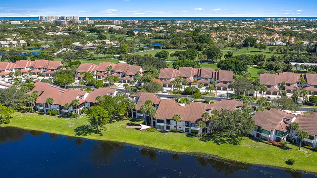 an aerial view of a city with lots of residential buildings lake and ocean view