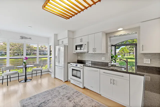 a kitchen with a stove a sink and a refrigerator