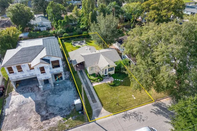 an aerial view of a house with a yard