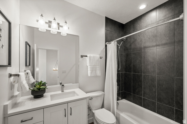 12241 900 East, Unit 7 Draper, UT 84020 - Photo 15 of 22 Bathroom featuring a white vanity with an integrated sink, brushed nickel faucet, and a large mirror
