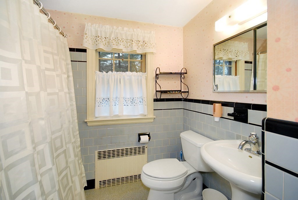 48 Wilson Road Concord, MA 01742 - Photo 25 of 41 a bathroom with a toilet a sink and a mirror