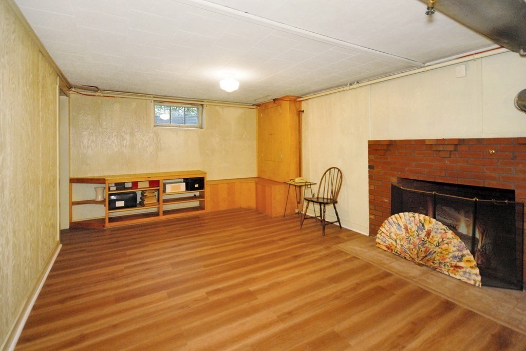 48 Wilson Road Concord, MA 01742 - Photo 27 of 41 a living room with furniture and a fireplace