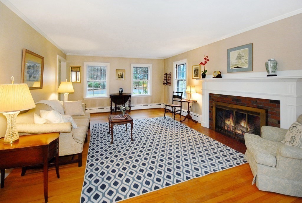 48 Wilson Road Concord, MA 01742 - Photo 29 of 41 a living room with furniture a flat screen tv and a fireplace