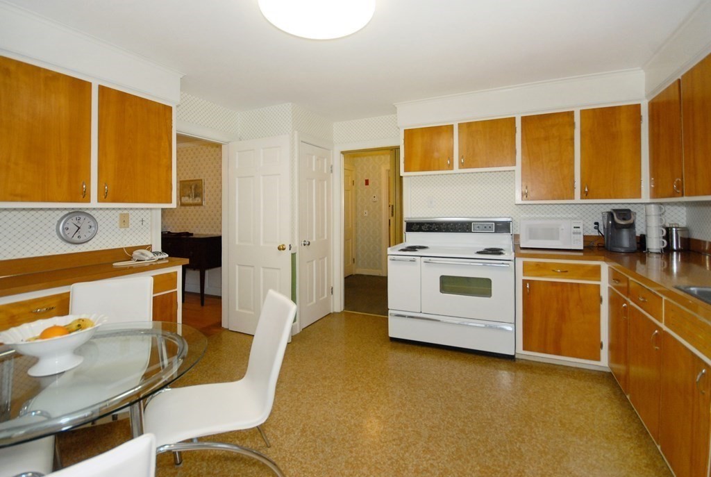48 Wilson Road Concord, MA 01742 - Photo 32 of 41 a kitchen with a stove a sink and a refrigerator