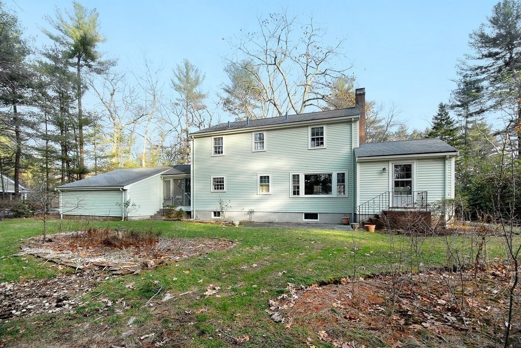 48 Wilson Road Concord, MA 01742 - Photo 34 of 41 a view of a yard in front of a house with plants and large tree