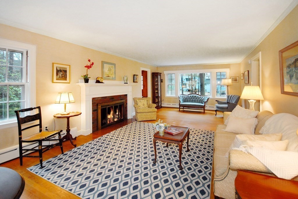 48 Wilson Road Concord, MA 01742 - Photo 8 of 41 a living room with furniture a rug and a fireplace