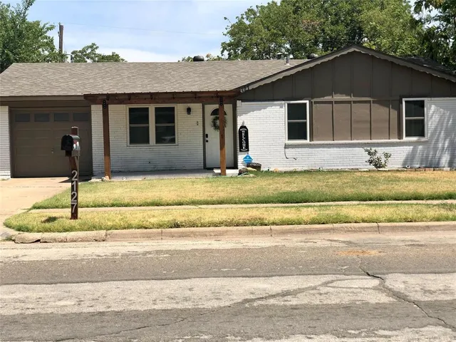 a house that has a tree in front of it