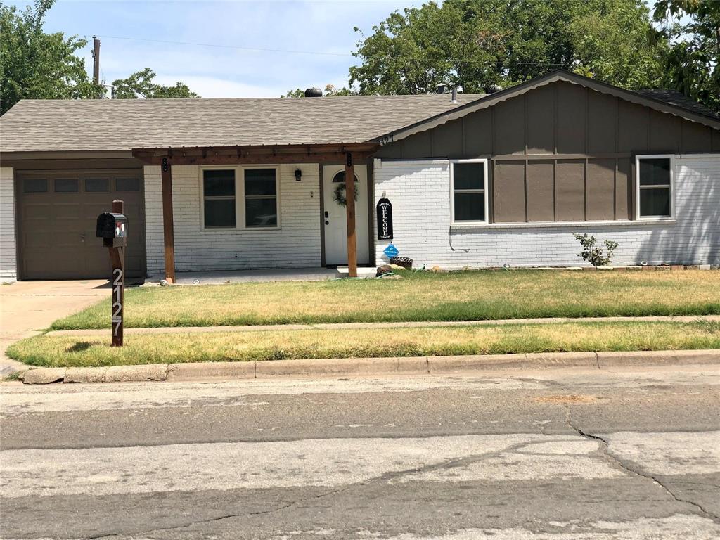 a house that has a tree in front of it
