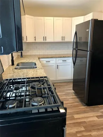 a kitchen with wooden cabinets and a stove top oven