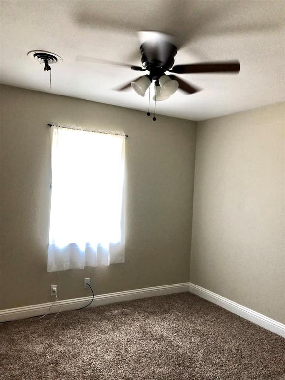 2127 East Mitchell Street Arlington, TX 76010 - Photo 8 of 20 an empty room with a window