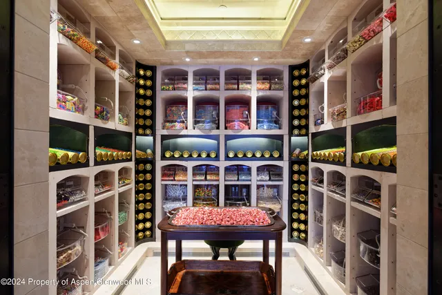 a view of a dining room with furniture a chandelier and wooden floor