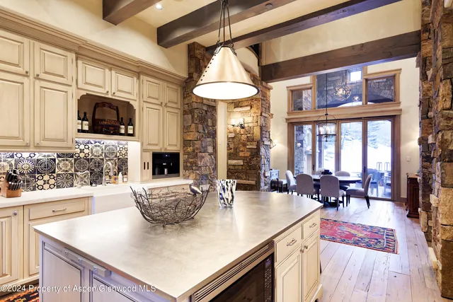 a living room with furniture a fireplace and a large window