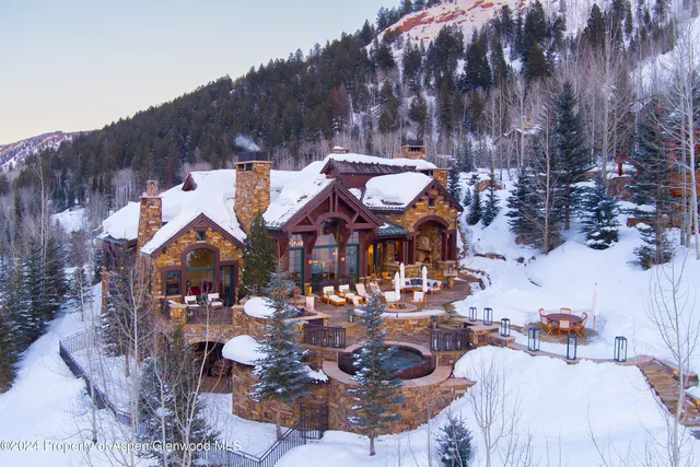 a living room with furniture a chandelier and a fireplace