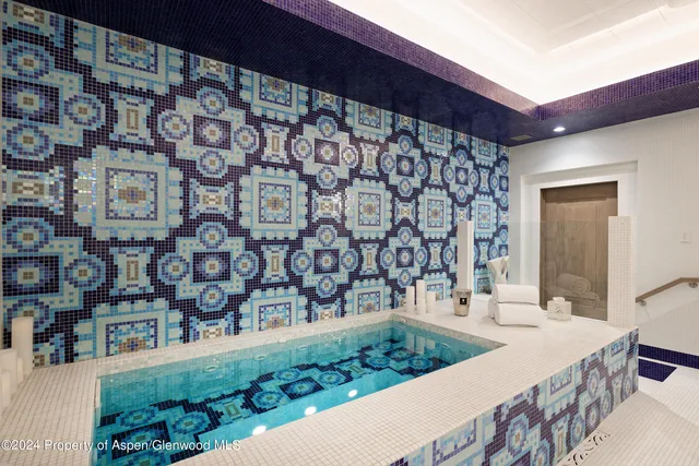 a view of a house with a barbeque grill and outdoor seating