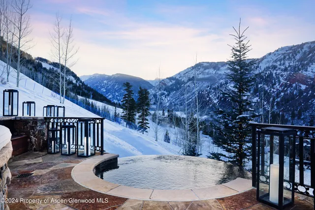 a view of a patio with chairs under an umbrella