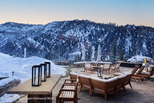 a building outdoor space with patio furniture and potted plants