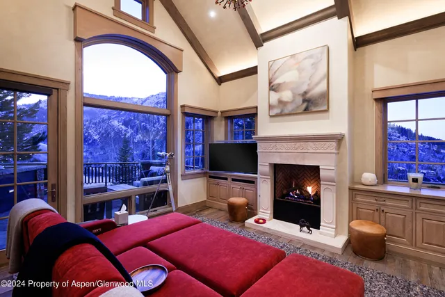a dining room with furniture and a floor to ceiling window