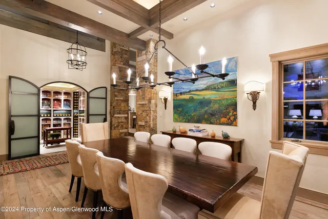 a kitchen with a table chairs and a wooden floor