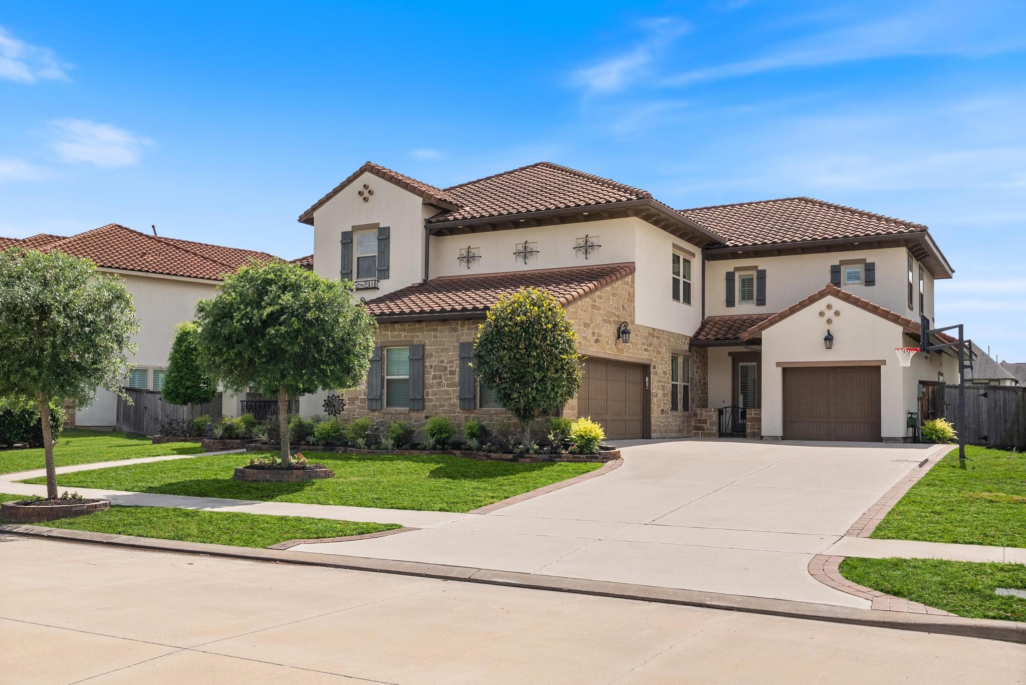 5403 Rouchel Brook Lane Sugar Land, TX 77479 - Photo 32 of 42 Expansive driveway with 3-car garage and a striking exterior showcasing timeless architecture.