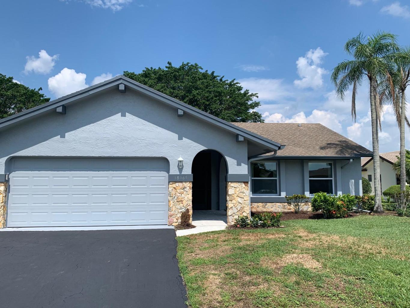 18065 Park Terrace Boca Raton, FL 33498 - Photo 2 of 20 a front view of a house with a yard and garage