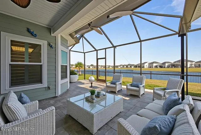 a view of an empty room and kitchen view