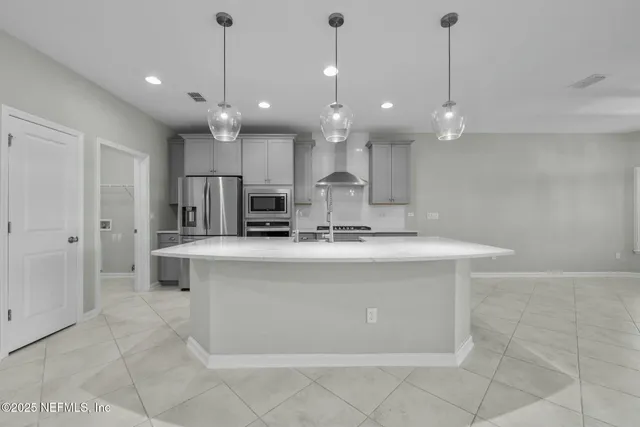 a kitchen with cabinets and stainless steel appliances