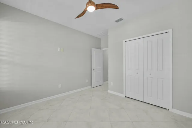 a front view of house with yard and trees in the background