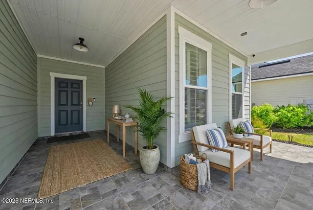 a view of a house with backyard and sitting area