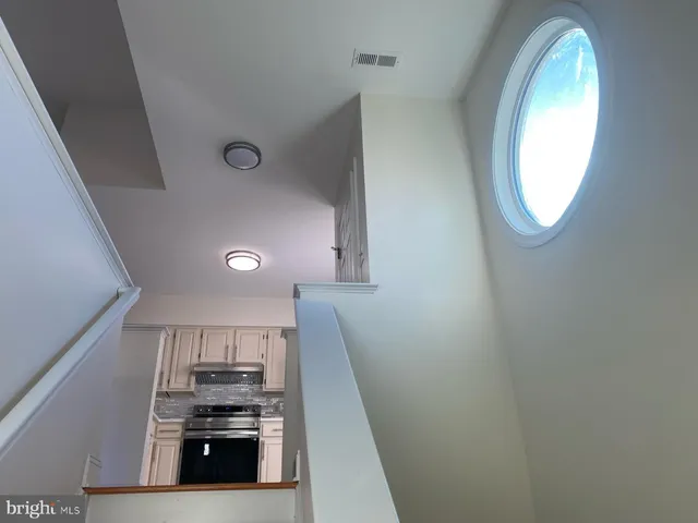 a view of a kitchen with stove and cabinets