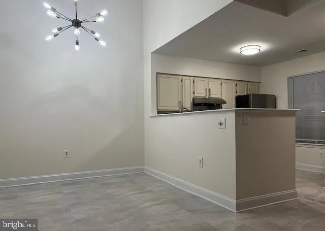 a view of a kitchen with a sink and cabinet