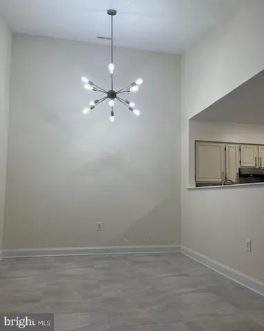 a view of a room with an empty space and a ceiling fan