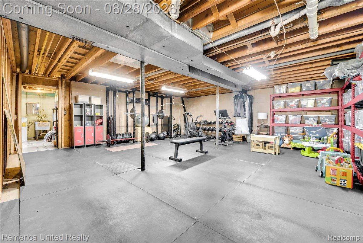 3687 Van Amberg Road Brighton, MI 48114 - Photo 29 of 56 Concrete flooring throughout this expansive lower level featuring exposed ceiling joists and support beams