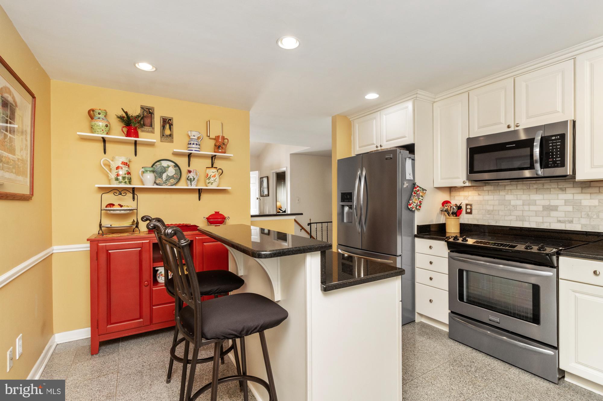 1002 Dunblane Road Towson, MD 21286 - Photo 15 of 59 a kitchen with stainless steel appliances granite countertop a refrigerator and a stove top oven
