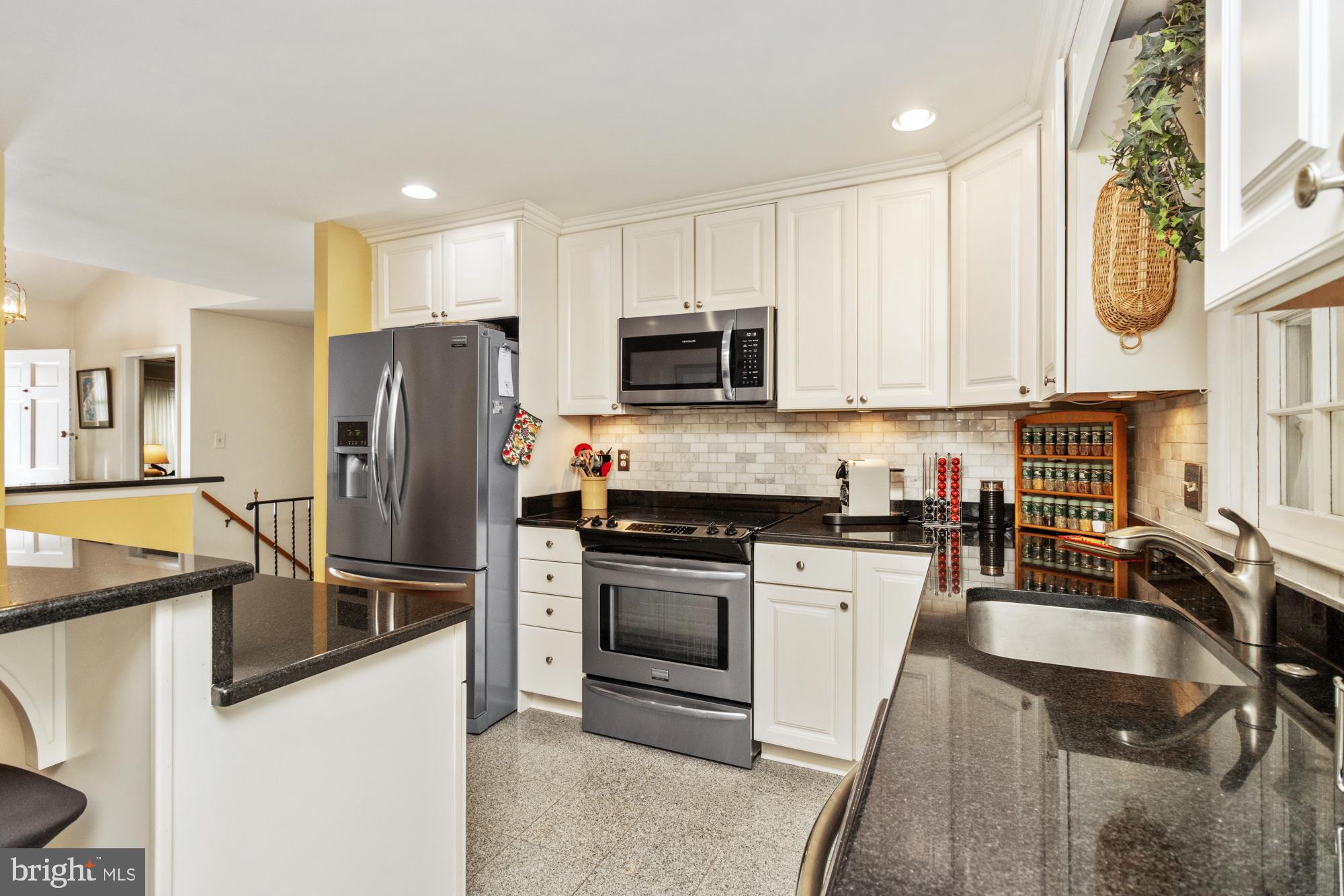 1002 Dunblane Road Towson, MD 21286 - Photo 16 of 59 a kitchen with stainless steel appliances granite countertop a refrigerator stove and sink