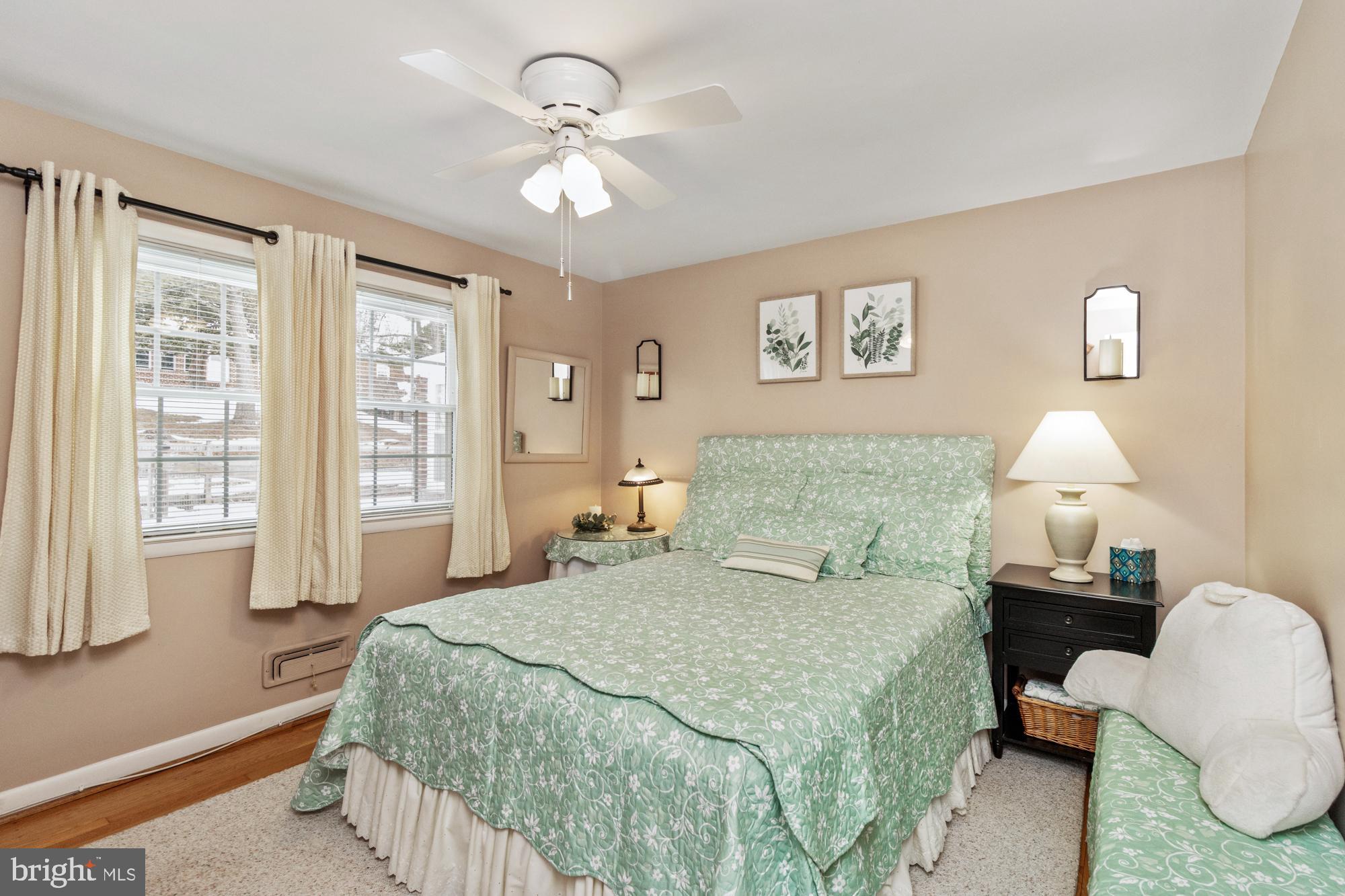 1002 Dunblane Road Towson, MD 21286 - Photo 25 of 59 a bedroom with a bed a lamp and a large window