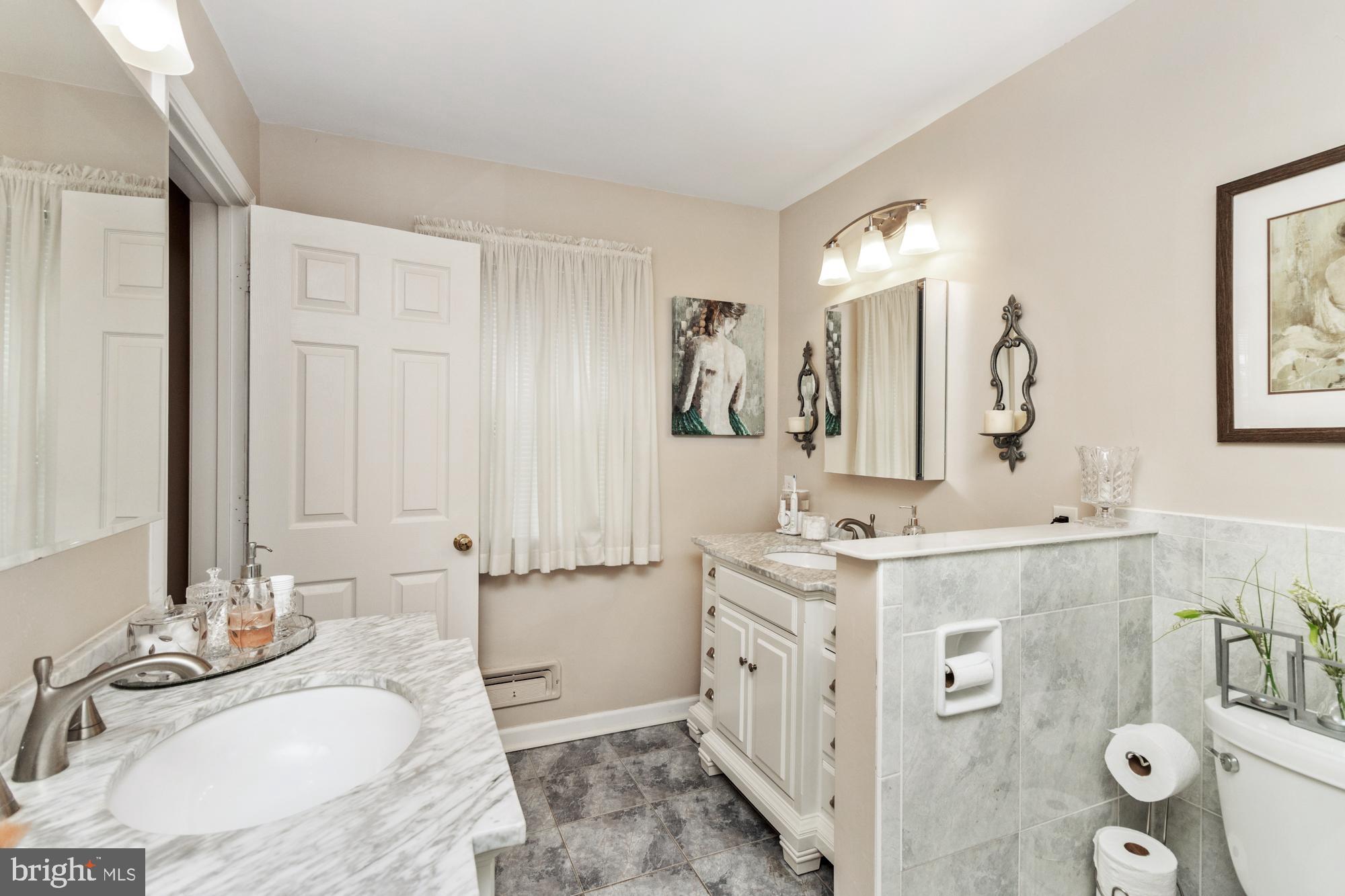 1002 Dunblane Road Towson, MD 21286 - Photo 38 of 59 a bathroom with a granite countertop double vanity sink mirror and