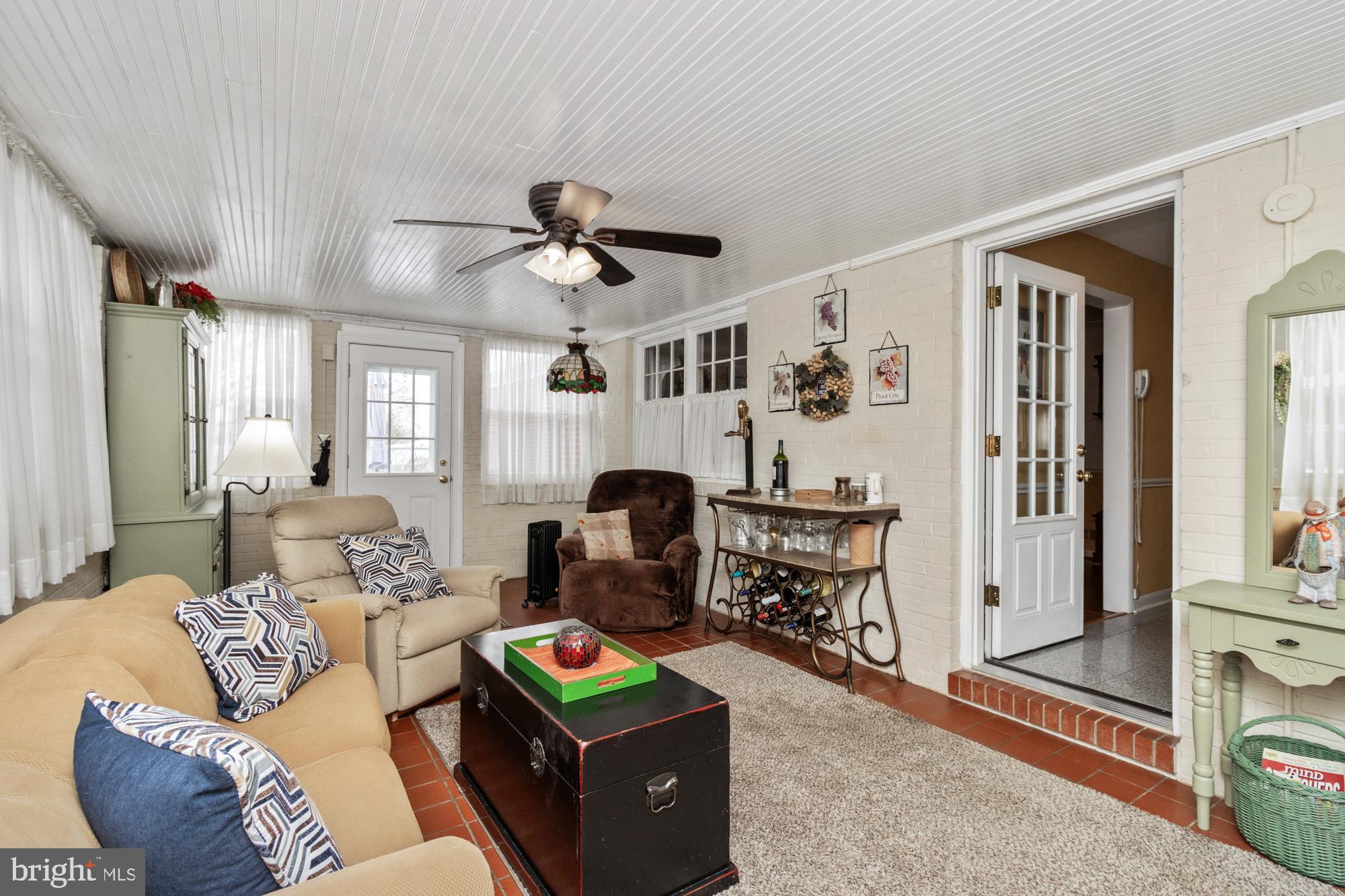 1002 Dunblane Road Towson, MD 21286 - Photo 40 of 59 a living room with furniture a fireplace and a flat screen tv