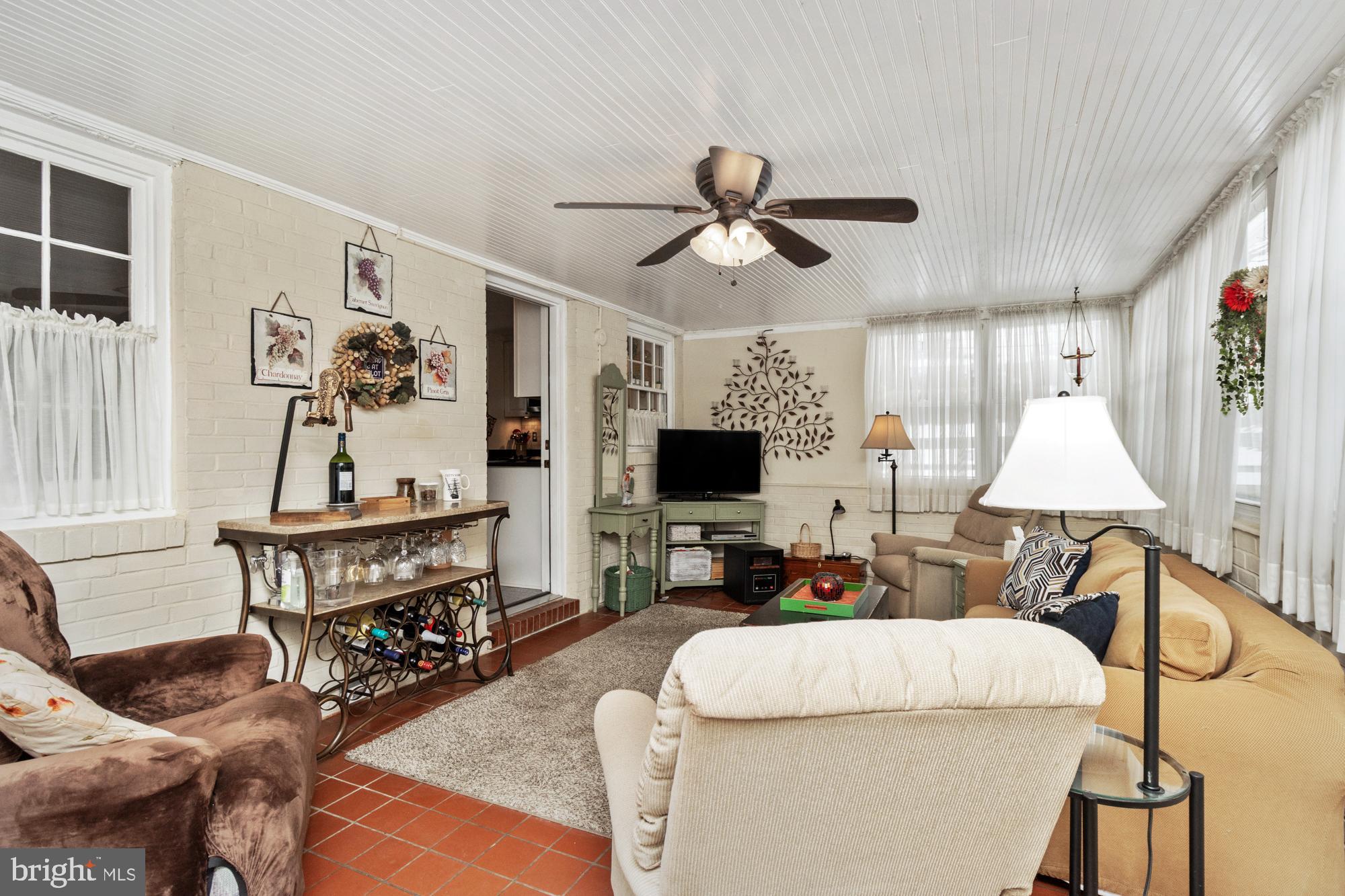 1002 Dunblane Road Towson, MD 21286 - Photo 41 of 59 a living room with furniture a flat screen tv and a table