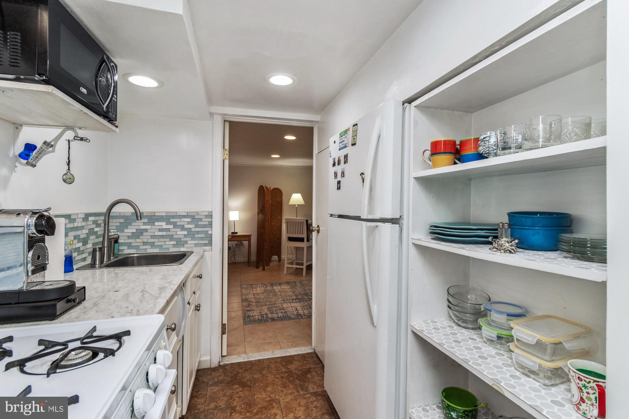1002 Dunblane Road Towson, MD 21286 - Photo 53 of 59 a kitchen with granite countertop a wooden floor and cabinets