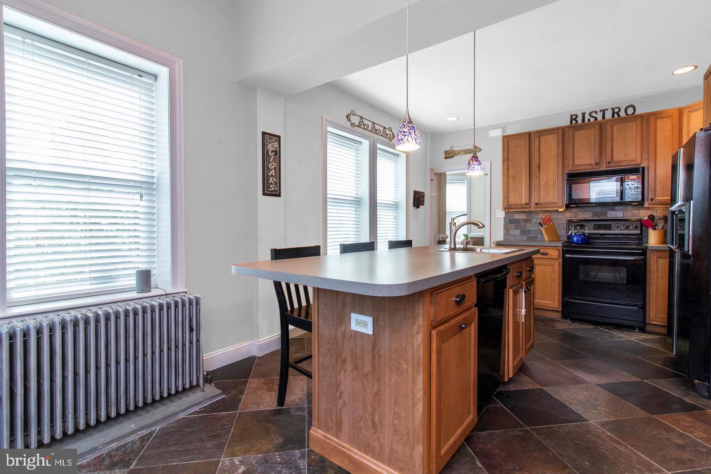 317-19 Rector Street Philadelphia, PA 19128 - Photo 11 of 29 a kitchen with stainless steel appliances a sink a stove a refrigerator and cabinets