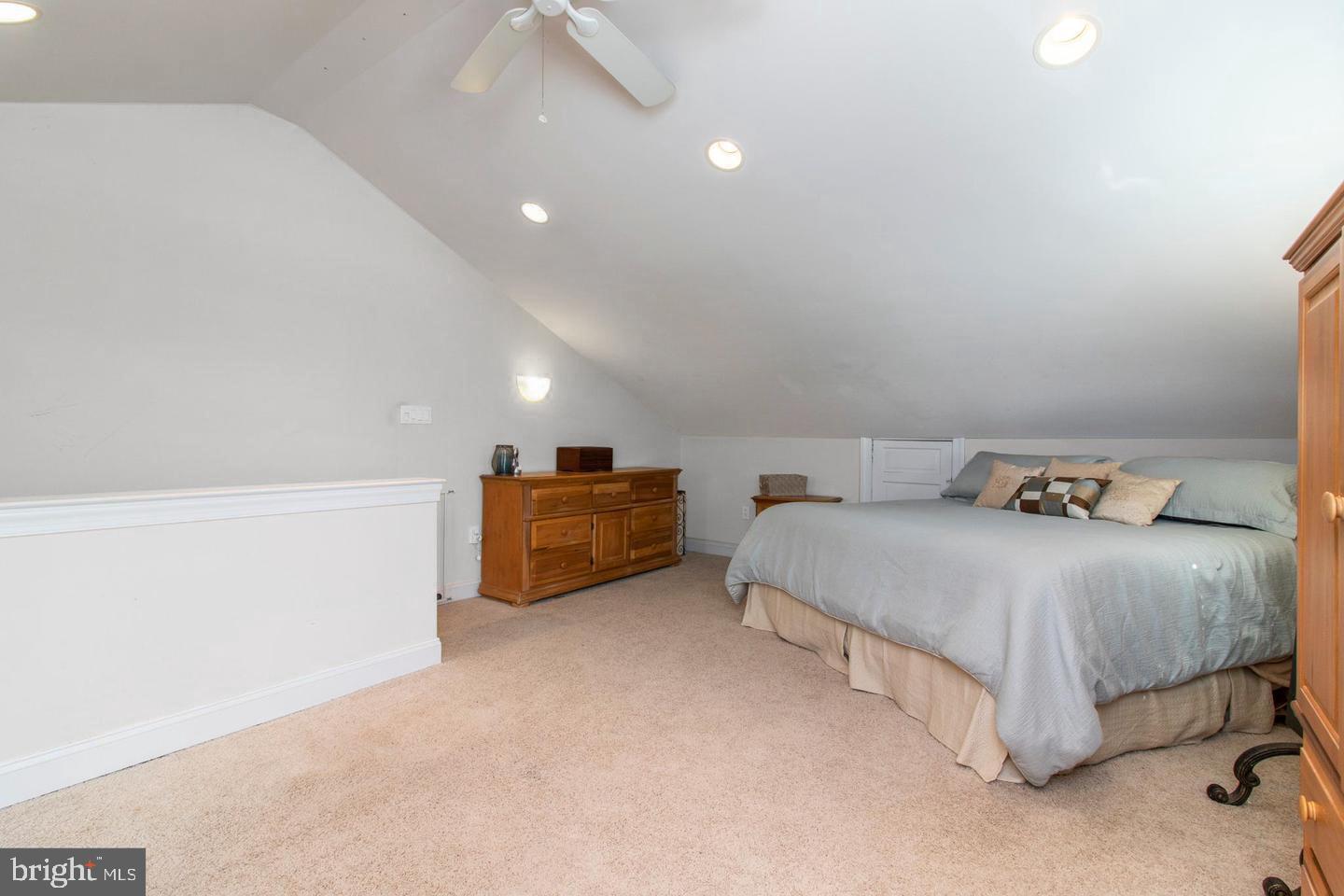 317-19 Rector Street Philadelphia, PA 19128 - Photo 20 of 29 a spacious bedroom with a bed and a couch