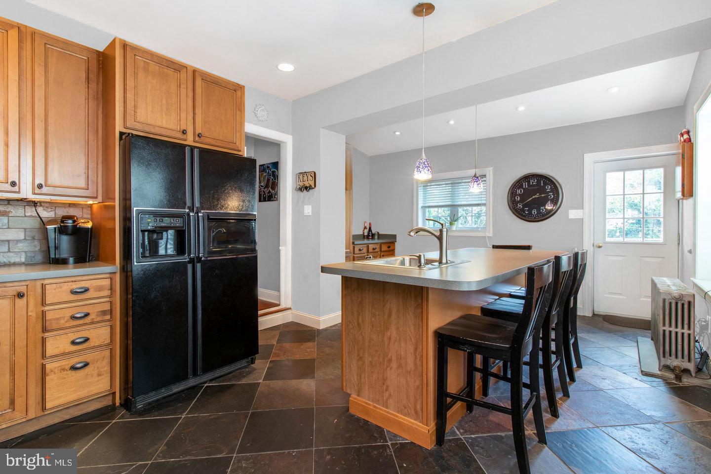 317-19 Rector Street Philadelphia, PA 19128 - Photo 9 of 29 a kitchen with stainless steel appliances a refrigerator a stove a sink and chairs