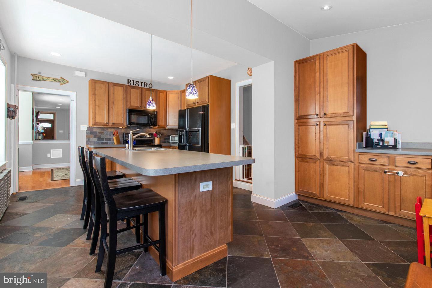 317-19 Rector Street Philadelphia, PA 19128 - Photo 10 of 29 a kitchen with a table chairs refrigerator and cabinets