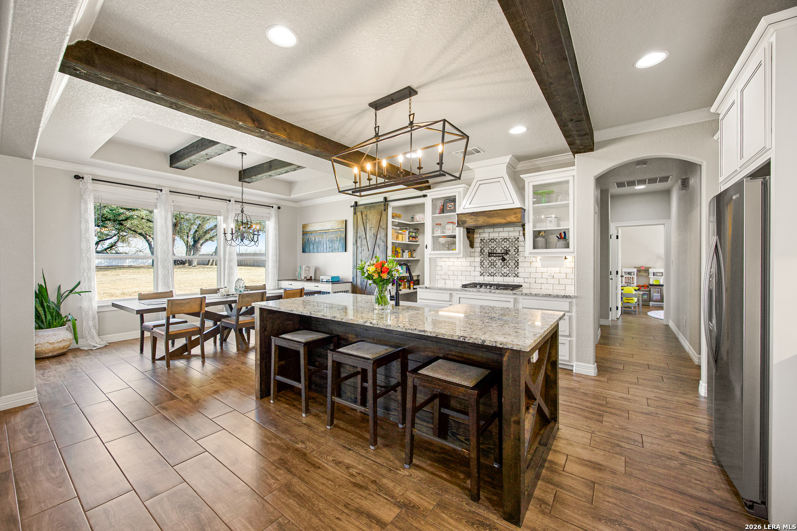 121 Western Way Adkins, TX 78101 - Photo 14 of 46 a dining hall with stainless steel appliances granite countertop a table chairs and a chandelier