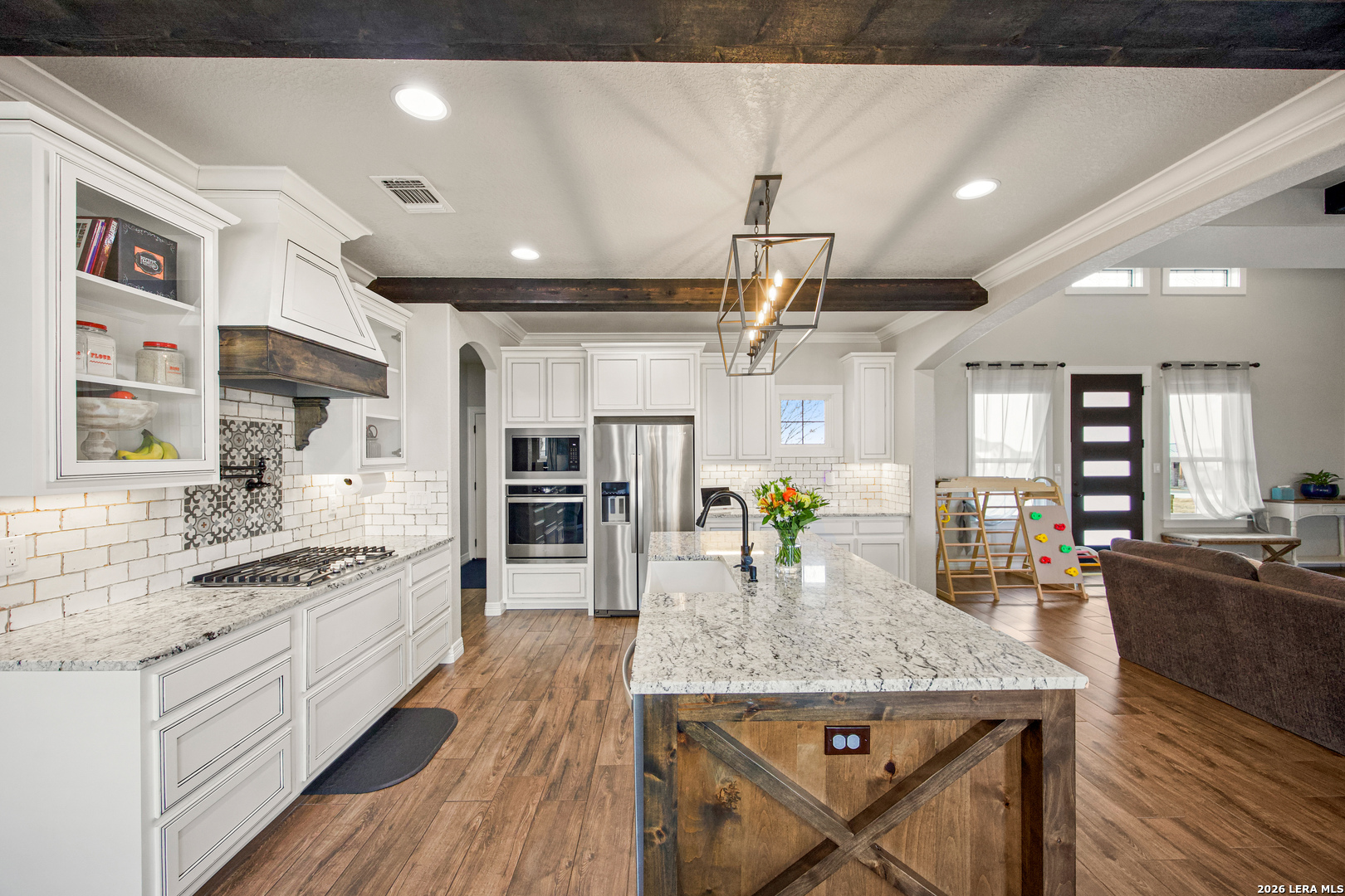 121 Western Way Adkins, TX 78101 - Photo 18 of 46 a kitchen with stainless steel appliances granite countertop a stove oven and a refrigerator