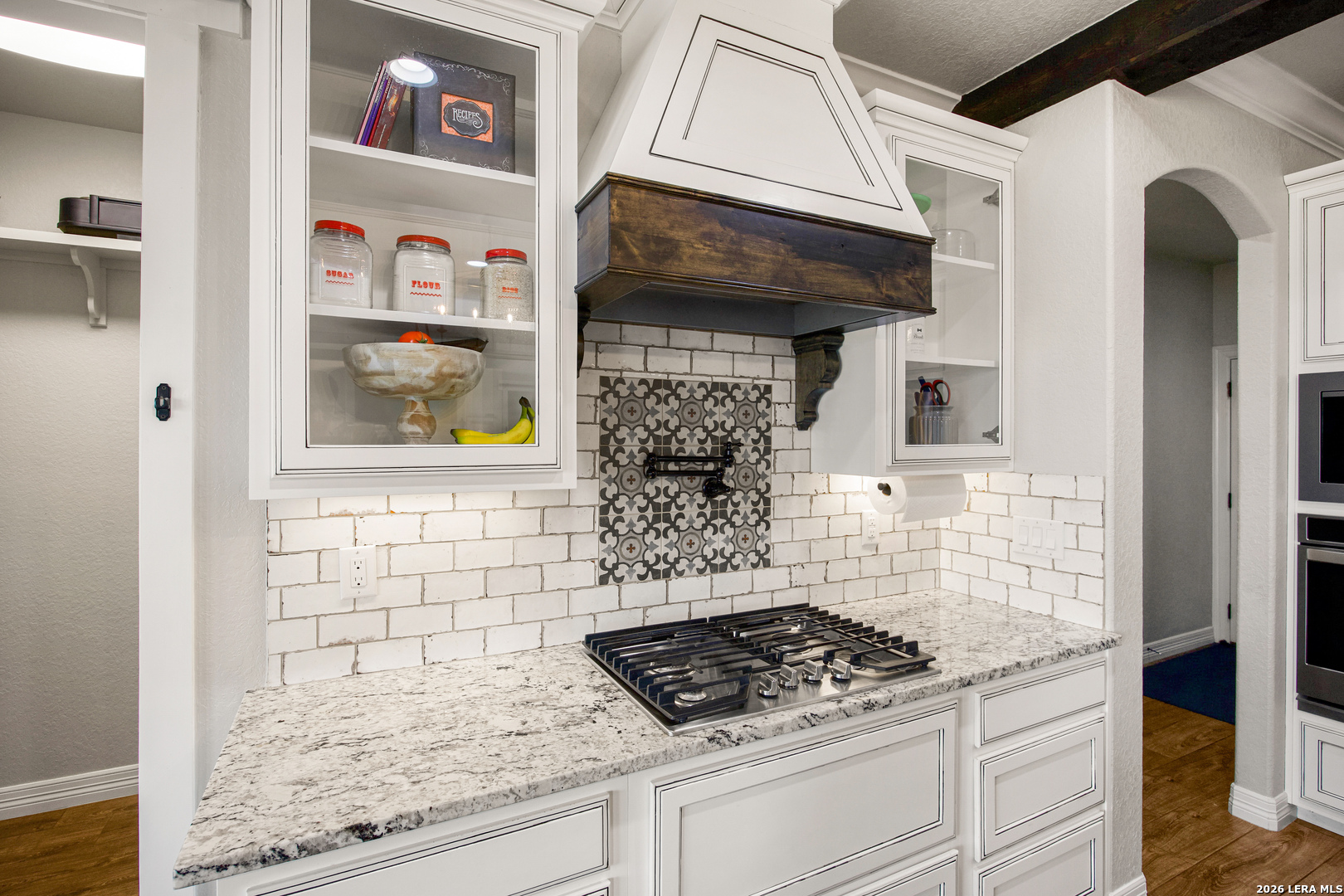 121 Western Way Adkins, TX 78101 - Photo 19 of 46 a kitchen with granite countertop a stove and cabinets