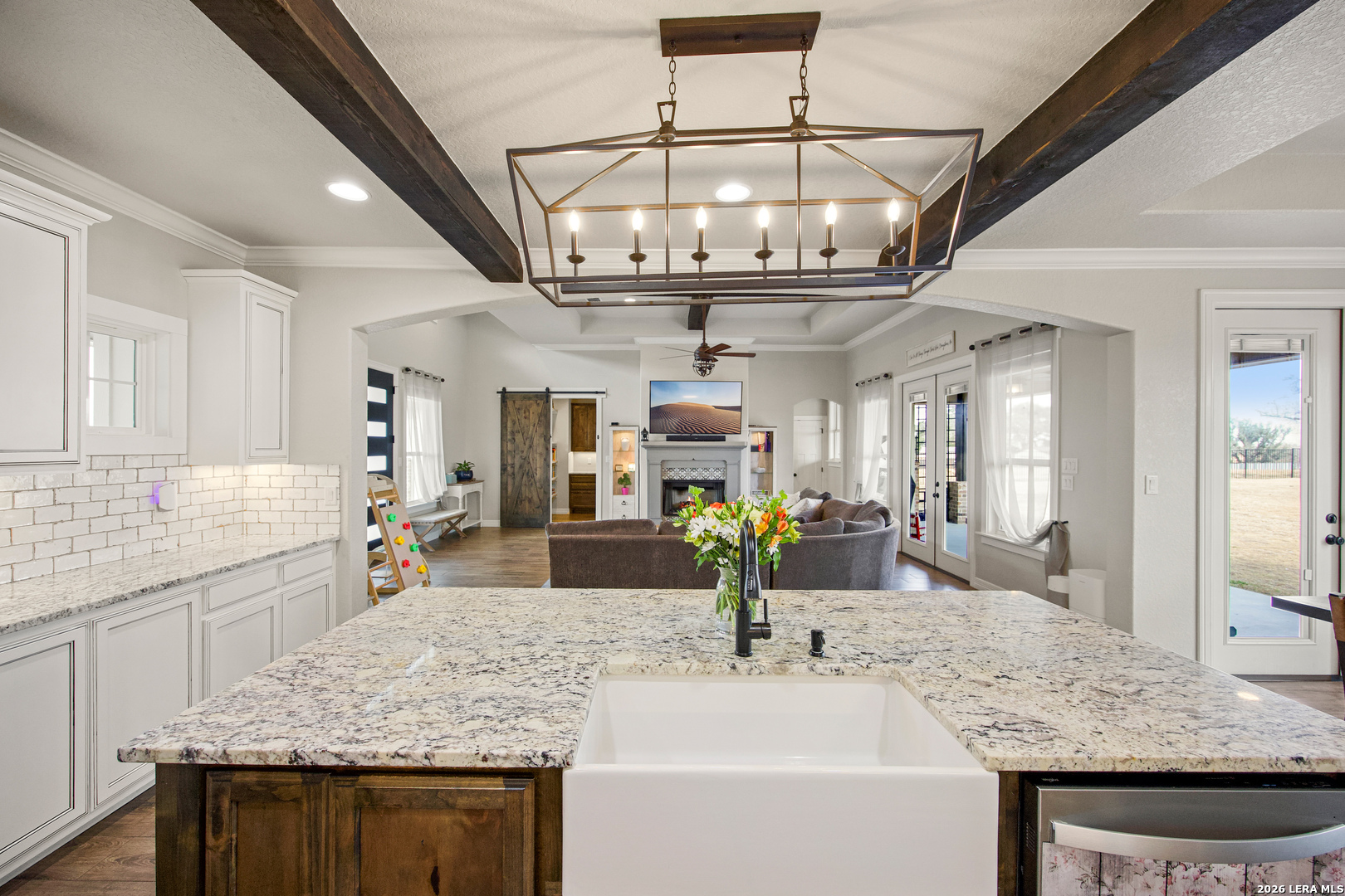 121 Western Way Adkins, TX 78101 - Photo 20 of 46 a bathroom with a granite countertop sink a large mirror and vanity