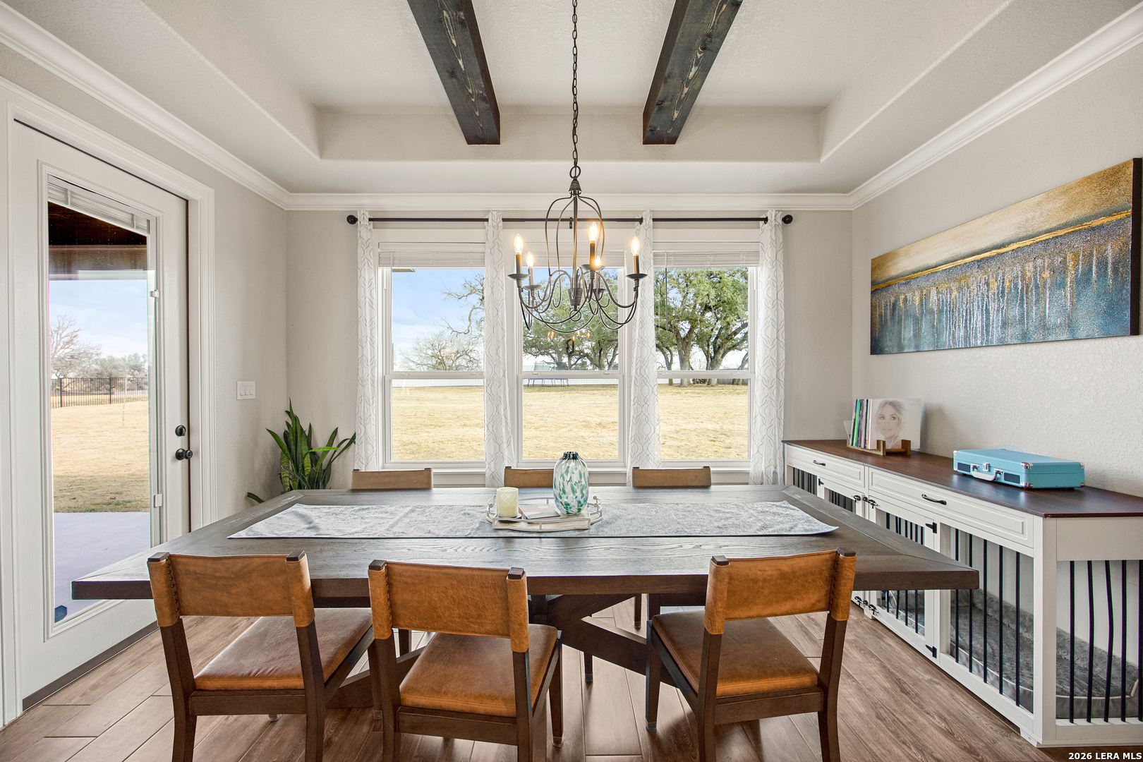 121 Western Way Adkins, TX 78101 - Photo 23 of 46 a dining room with furniture a chandelier and wooden floor